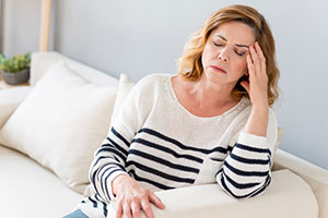Photo of a lady in pain with a headache or migraine