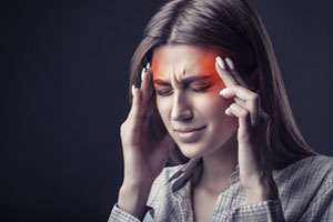 Woman holding her temples from headache pain